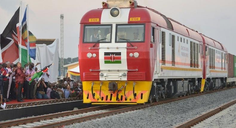 Kenyan President Uhuru Kenyatta flags off a cargo train at the port city of Mombasa on May 30, 2017, as it leaves the container terminal on its inaugural journey to Nairobi