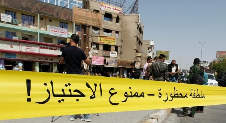 Iraqi security forces cordon off the site of a suicide bomb attack in Baghdad's Jadida neighbourhood on September 27, 2016