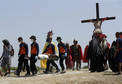 PHILIPPINES HOLY WEEK (Penitent is nailed to a wooden cross during the re-enactment of the crucifixion of Jesus Christ on Good Friday)