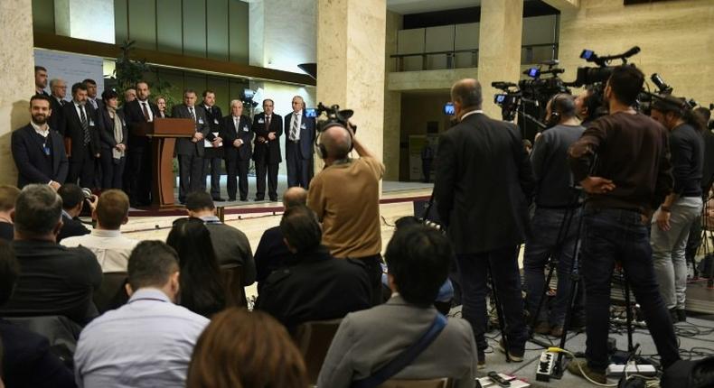 Syria's main opposition High Negotiations Committee (HNC) leader Nasr al-Hariri (C) gives a press conference next to delegates during the Intra-Syrian peace talks at the European headquarters of the United Nations in Geneva, on March 3, 2017