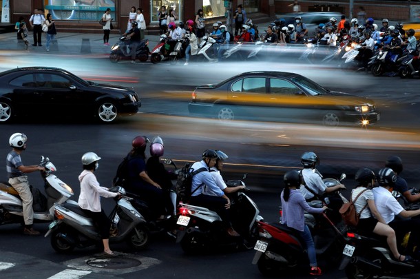 Motorcyclists stop at an intersection in Taipei