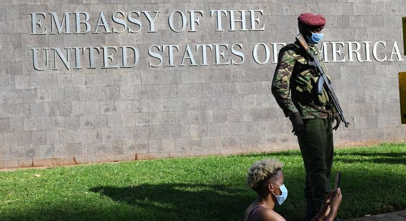 A paramilitary policeman stands guard next to a protester as they march during a demonstration in solidarity with the global Black Lives Matter movement as they protest over police brutality and white supremacy in the United States (US), Kenya and globally, outside the US Embassy in Nairobi on June 2, 2020.  (Photo by SIMON MAINA/AFP via Getty Images)