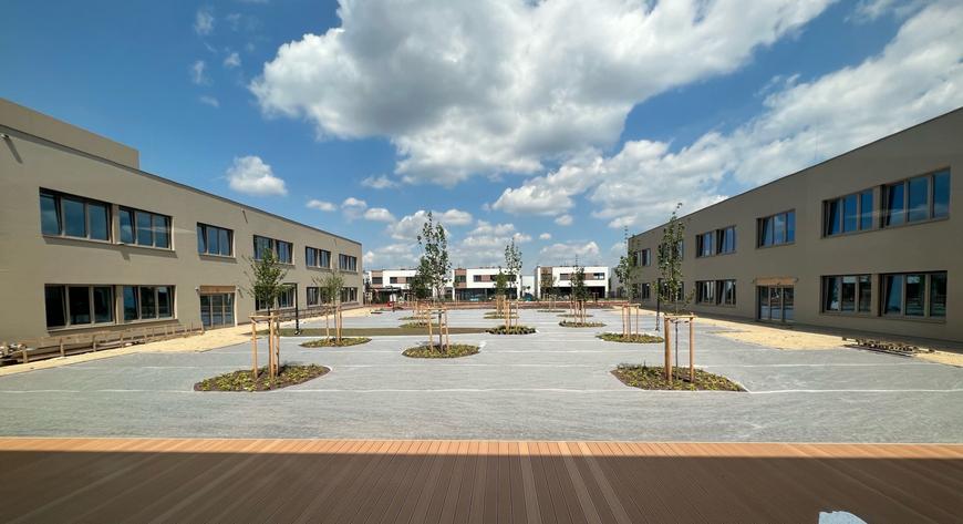 Na dziedzińcu przedszkola i szkoły zaprojektowano drzewa i zielone trawniki
