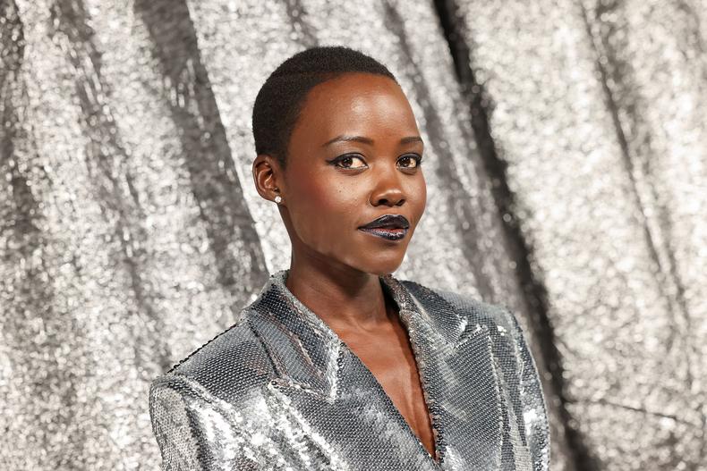 Oscar winner Lupita Nyong'o posed against the silver backdrop in a sequinned silver blazer dress.