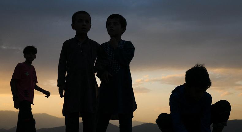 Children play marbles on a hill top in Kabul, Afghanistan on August 4, 2022.
