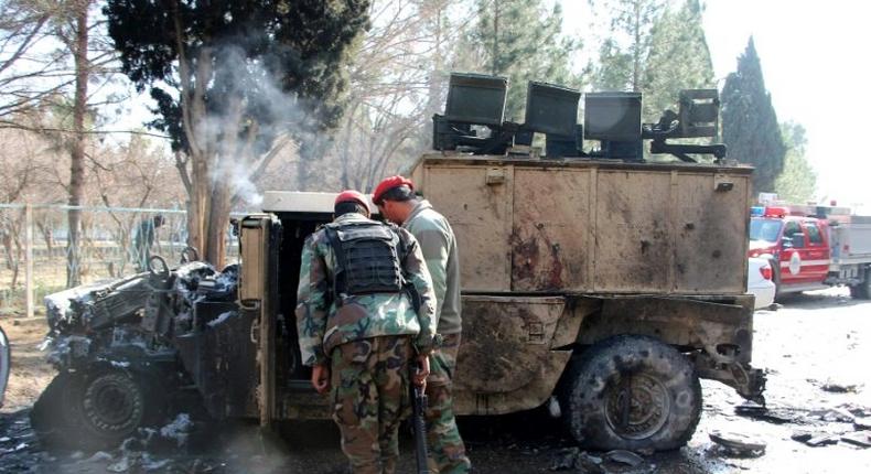 Afghan National Army (ANA) soldiers investigate a suicide car bomb attack in Lashkar Gah in Helmand Province on February 11, 2017