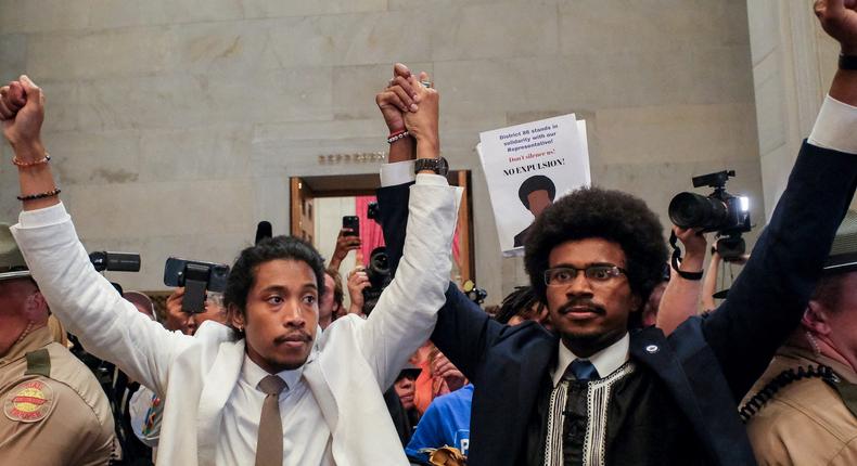 Justin Pearson and Justin Jones raise their hands after being expelled from their seats in Nashville.Kevin Wurm/Reuters