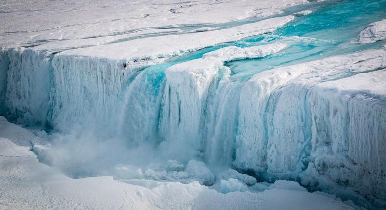 A waterfall caused by surface melt pours into a fracture in Antarctica's Nansen ice shelf.