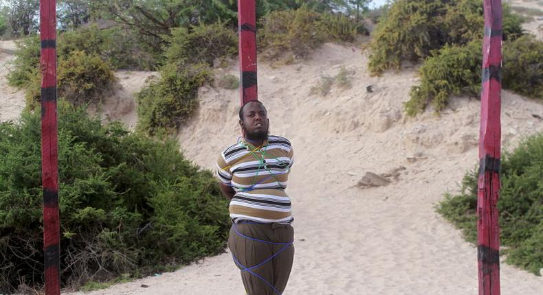 Hassan Hanafi, a former media officer for the Somali Islamist group al Shabaab, stands tied to a pole before his execution by shooting at close range on a field in General Kahiye Police Academy in Somalia's capital Mogadishu, April 11, 2016. 