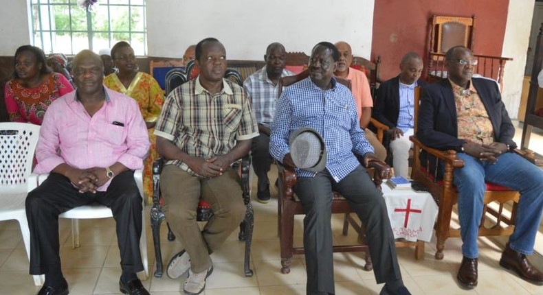 Raila Odinga with Muhoho Kenyatta and Raphael Tuju during a memorial service for Jaramogi Oginga and Fidel Odinga in Bondo