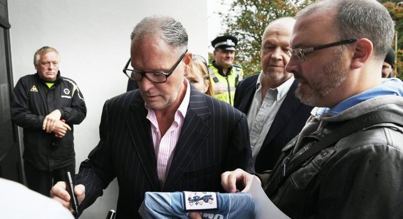 Former England footballer Paul Gascoigne (2L) signs autographs as he arrives at Dudley Magistrates' Court in Dudley, central England on September 19, 2016