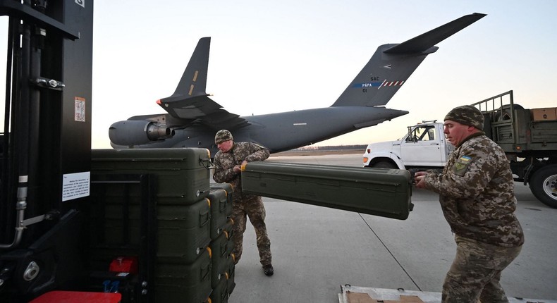 Ukrainian troops unload US-made FIM-92 Stinger missiles and the other military assistance shipped from Lithuania at Boryspil Airport in Kyiv, February 13, 2022.