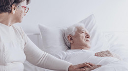 Elderly woman visiting sick husband