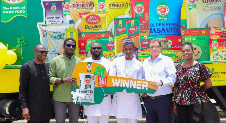 L- R: The FMN National Sales Operations Manager (B2C) Sales, Isaac Oladebo; Head of Sales, (B2C), Mr. Ademola Adeoye; Head of Marketing, Food, Mr. Ilyas O. Kazeem; Winner, FMN – Golden Penny Redistribution Truck & GM, Toluwatimofe Resources Ventures, Mr.  Mohammed Jimoh; The MD, Food Division, Mr. Devlin M. Hainsworth; and the Trade Marketing Manager (B2C), Ms. Abiola I. Ademuwagun; at the FMN, Golden Penny place, Apapa, Lagos during the B2C Redistribution Truck reward event.