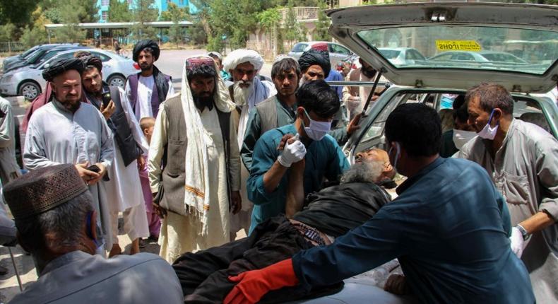 A  man injured in an explosion at a cattle market is brought to in Lashkar Gah, Helmand province
