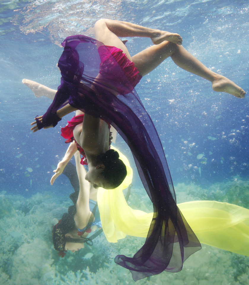 A promoter wearing a traditional hanbok performs in a water tank at the "Underwater Hanbok Fashion Show" during a photo call in Seoul