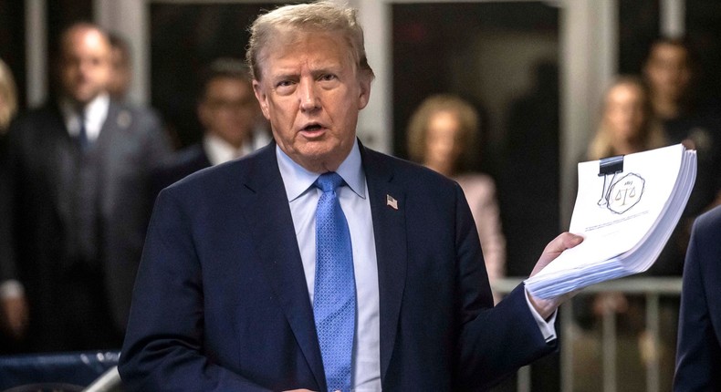 Former US President Donald Trump speaks to the press as he arrives to attend his trial in Manhattan Criminal Court in New York City.DAVE SANDERS/POOL/AFP via Getty Images