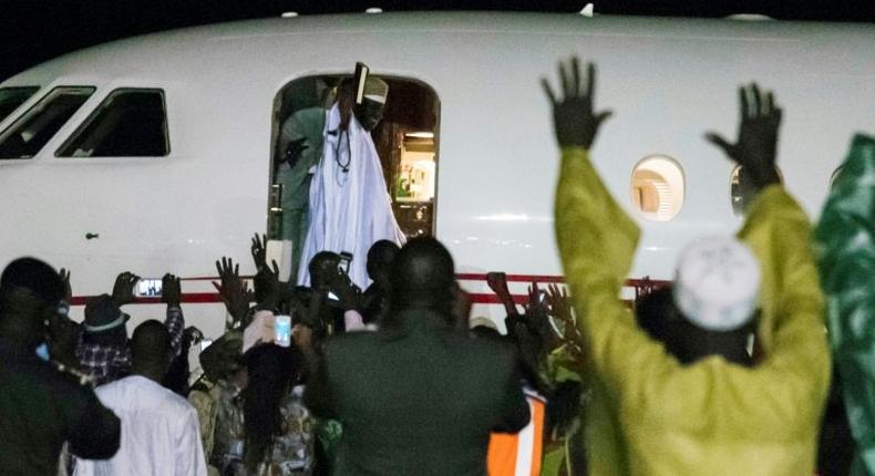 Former president Yaya Jammeh (C), the Gambia's leader for 22 years, waves from the plane as he leaves the country on 21 January 2017 in Banjul