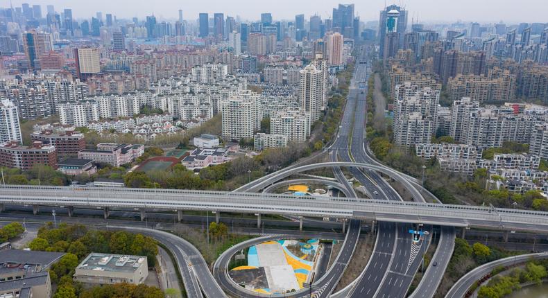 Aerial view of empty roads and residential blocks in Pudong district after Shanghai imposed a citywide lockdown to halt the spread of COVID-19 epidemic .