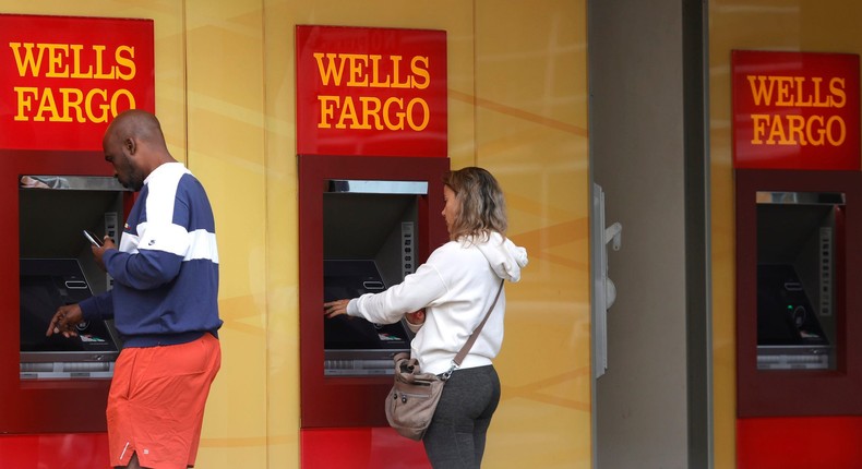 Wells Fargo customers use ATMs outside of a Wells Fargo bank on July 14, 2021 in San Francisco, California.