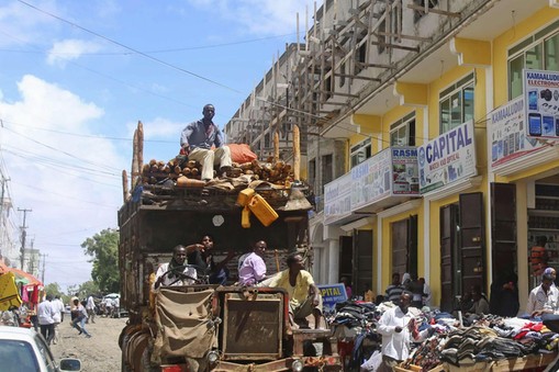 A truck drives through Bakara market in Mogadishu October 5, 2013. Street lamps now brighten some of Mogadishu's battle-scarred roads and couples hold hands at the seaside next to bombed-out beachfront buildings, a scene that would have been unthinkable w