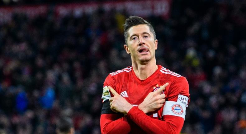 Robert Lewandowski celebrates scoring his 100th goal at the Allianz Arena in Bayern colours