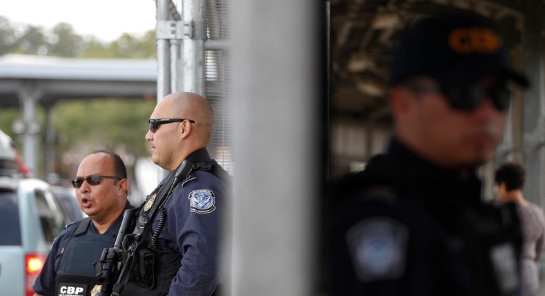 Customs and Border Protection agents monitor cars, left, and pedestrians enter the U.S. through a walkway, at the Puerta Mexico international bridge.