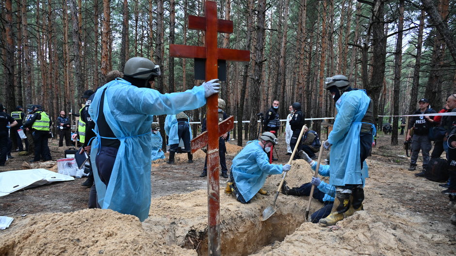 Ukraińscy technicy kryminalni podczas prac w lesie na obrzeżach Izium