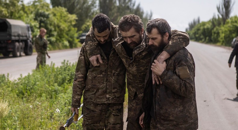 Ukrainian prisoners of war after a swap in Ukraine's Donetsk region in May 2023.REUTERS/Yevhenii Zavhorodnii