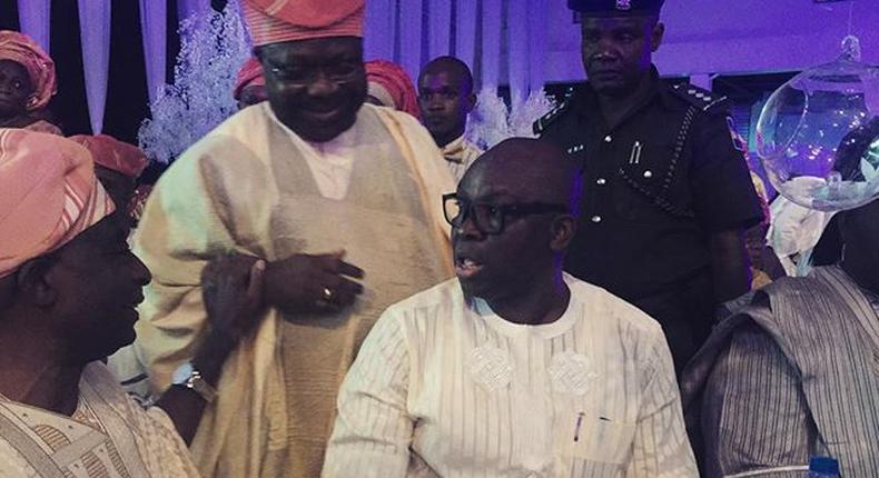 Senator Iyiola Omisore and Governor Fayose enjoy a quick chat while guests watched on