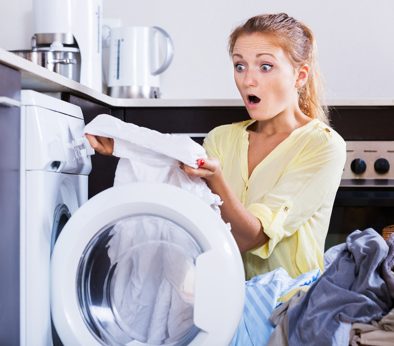 Dismayed,Blonde,Girl,Looking,At,Stains,On,Linen,After,Laundry