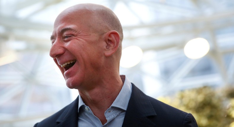 FILE PHOTO: Amazon founder and CEO Jeff Bezos laughs as he talks to the media while touring the new Amazon Spheres during the grand opening at Amazon's Seattle headquarters in Seattle, Washington, U.S., January 29, 2018.   REUTERS/Lindsey Wasson/File Photo