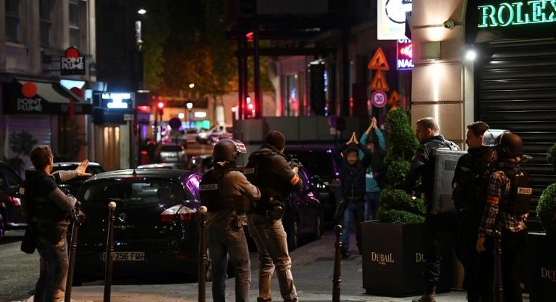 Police check passersby near the Champs Elysees in Paris after a shooting which left one officer dead and two wounded