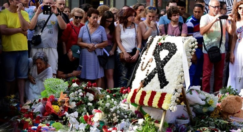 Flowers and candles are placed on Las Ramblas boulevard in Barcelona in tribute to the victims of the twin attacks in Spain