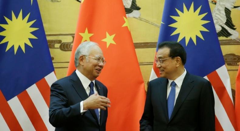 Malaysia's Prime Minister Najib Razak (left) and China's Premier Li Keqiang attend a signing ceremony at the Great Hall of the People in Beijing, on November 1, 2016