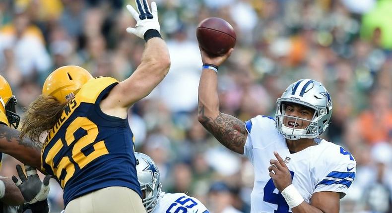 Clay Matthews of the Green Bay Packers attempts to block a pass attempt from Dak Prescott of the Dallas Cowboys during the second quarter at Lambeau Field on October 16, 2016 in Wisconsin