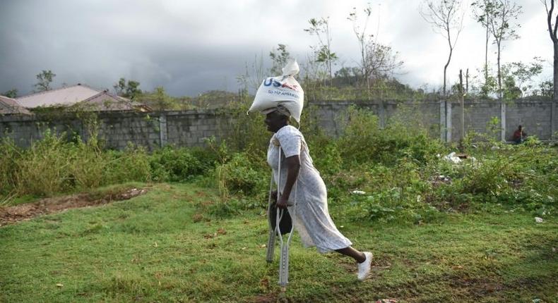 Sara, 66, receives food from the World Food Programme in the commune of Maniche, in Haiti, last month