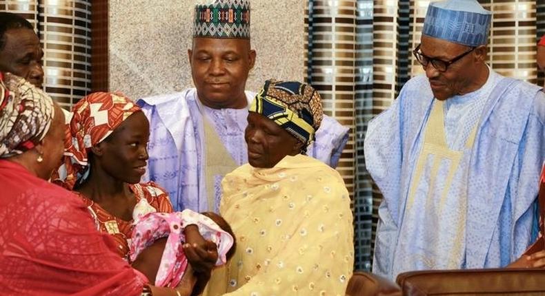 Amina Ali Darsha Nkeki, a Nigerian schoolgirl rescued after over two years of captivity with BokoHaram militants, presents her child to President Muhammadu Buhari in Abuja, Nigeria May 19, 2016. 