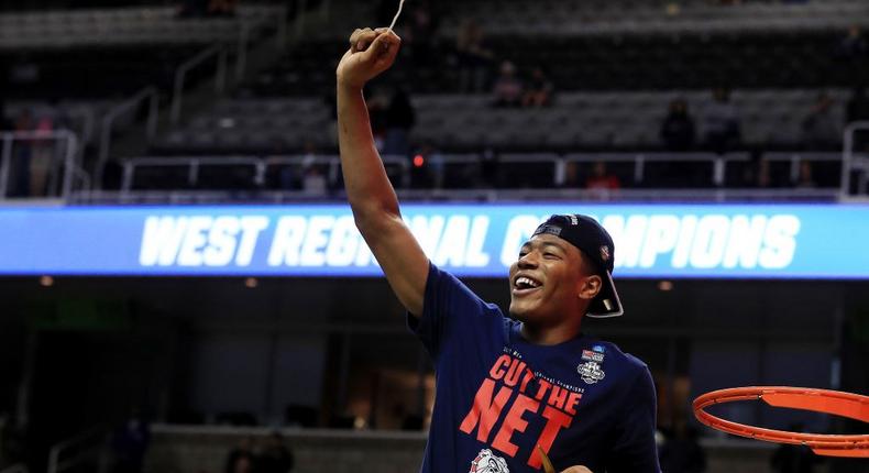 Rui Hachimura of the Gonzaga Bulldogs cuts down the net.