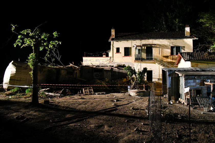 A derailed train carriage is seen toppled in the town of Adendro in northern Greece