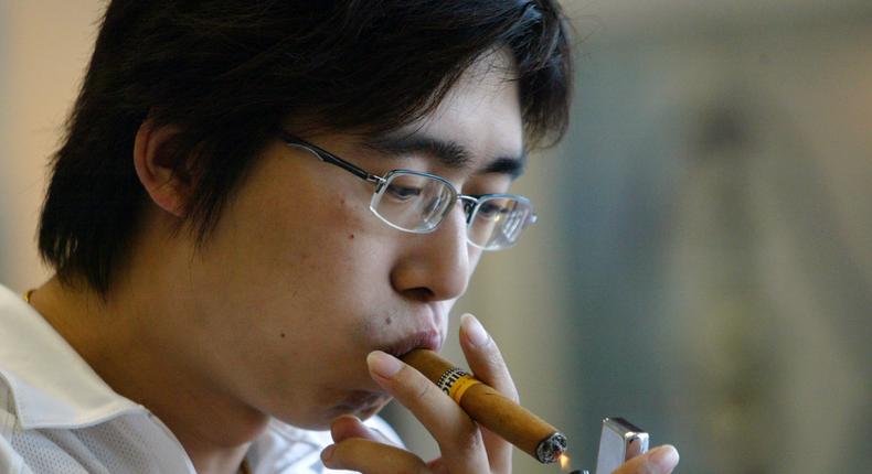 A man samples a Cuban Cohiba cigar, made by Habanos, at an event in Shanghai in June 2006.
