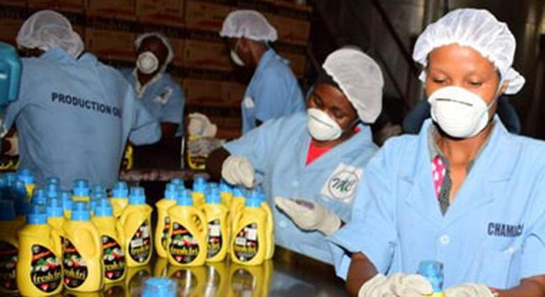 Workers pack Pwani Oil products