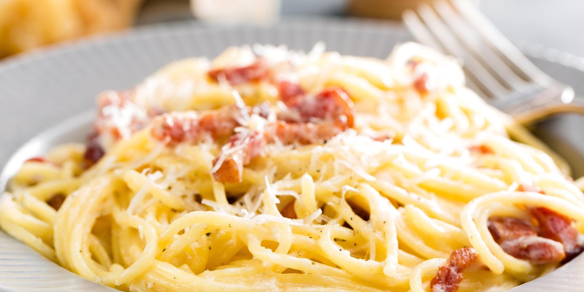 Carbonara pasta, spaghetti with pancetta, egg, hard parmesan cheese and cream sauce. Traditional italian cuisine. Pasta alla carbonara