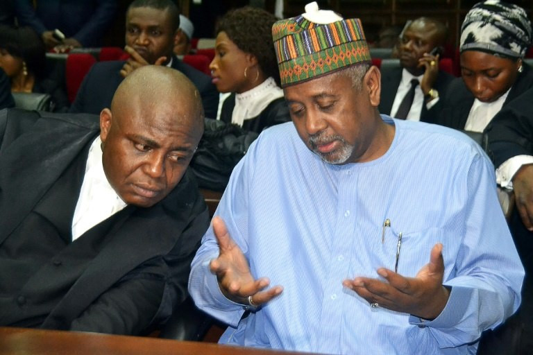 Former national security adviser of ex-president Goodluck Jonathan, Sambo Dasuki (right), speaks with his lawyer Ahmed Raji, during his trial at the federal high court in Abuja, on September 1, 2015 (The Nation)