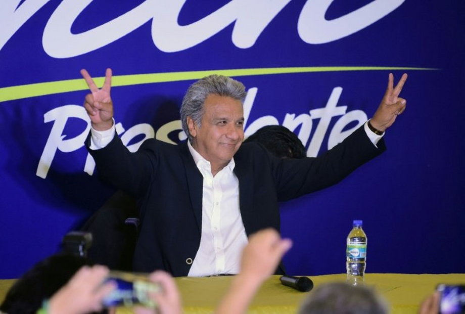 Lenin Moreno, the presidential candidate of the governing Alianza Pais party, makes the "V for victory" sign to supporters at a hotel in Quito shortly before the results of the country's general elections are announced on February 19, 2017.