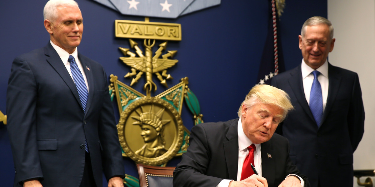 President Donald Trump signs an executive order on January 27, 2017.