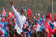 Rwandan President Paul Kagame of the ruling Rwandan Patriotic Front waves to his supporters during h