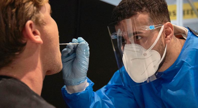 A flight passenger from South Africa is tested for COVID-19 at Amsterdam Schiphol airport on December 2, 2021.