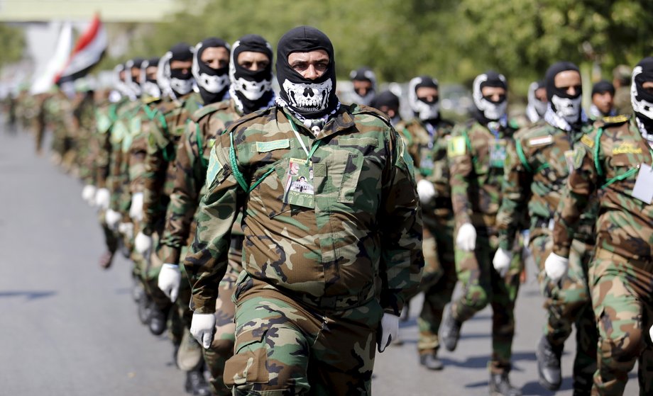 Iraqi Shiite Muslim men from Hashid Shaabi (Popular Mobilization) march during a parade marking the annual al-Quds Day, or Jerusalem Day, on the last Friday of the Muslim holy month of Ramadan in Baghdad, July 10, 2015.