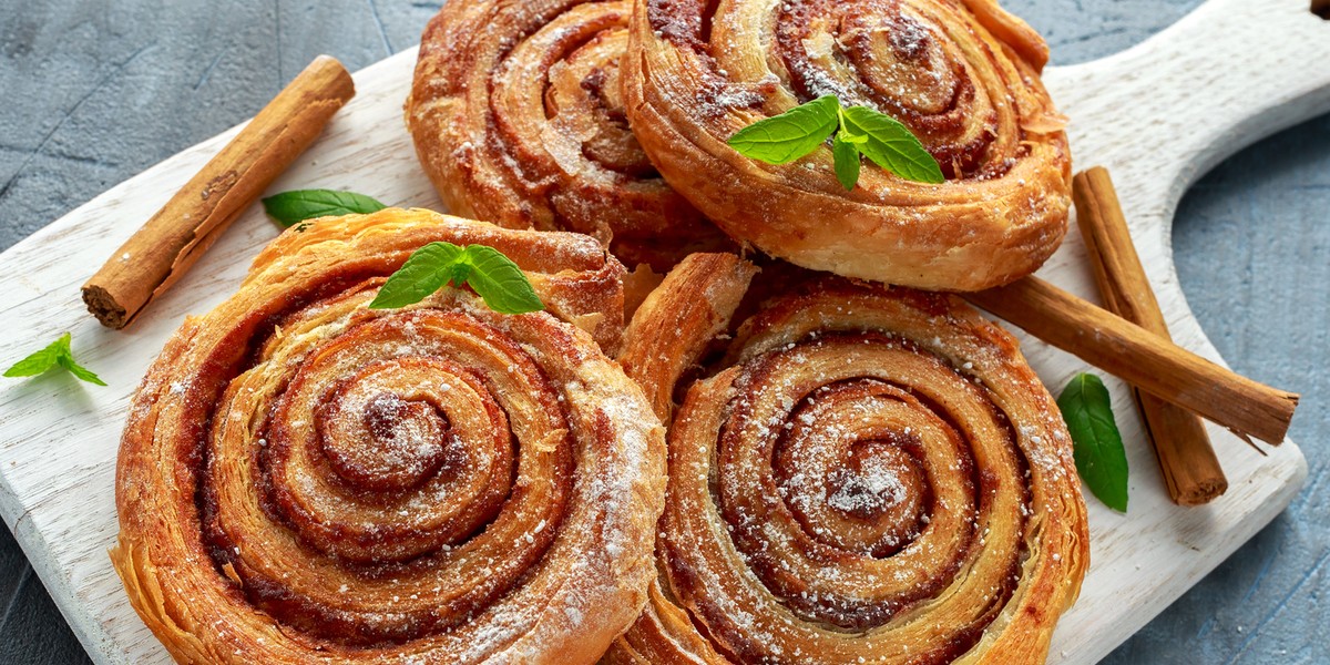 Freshly Baked Traditional Sweet Cinnamon Rolls, Swirl on white wooden board